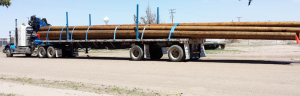 Adams Industries Trailer hauling wood logs