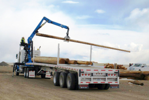 Adams-industries-truck-loading-wood-logs-our-company